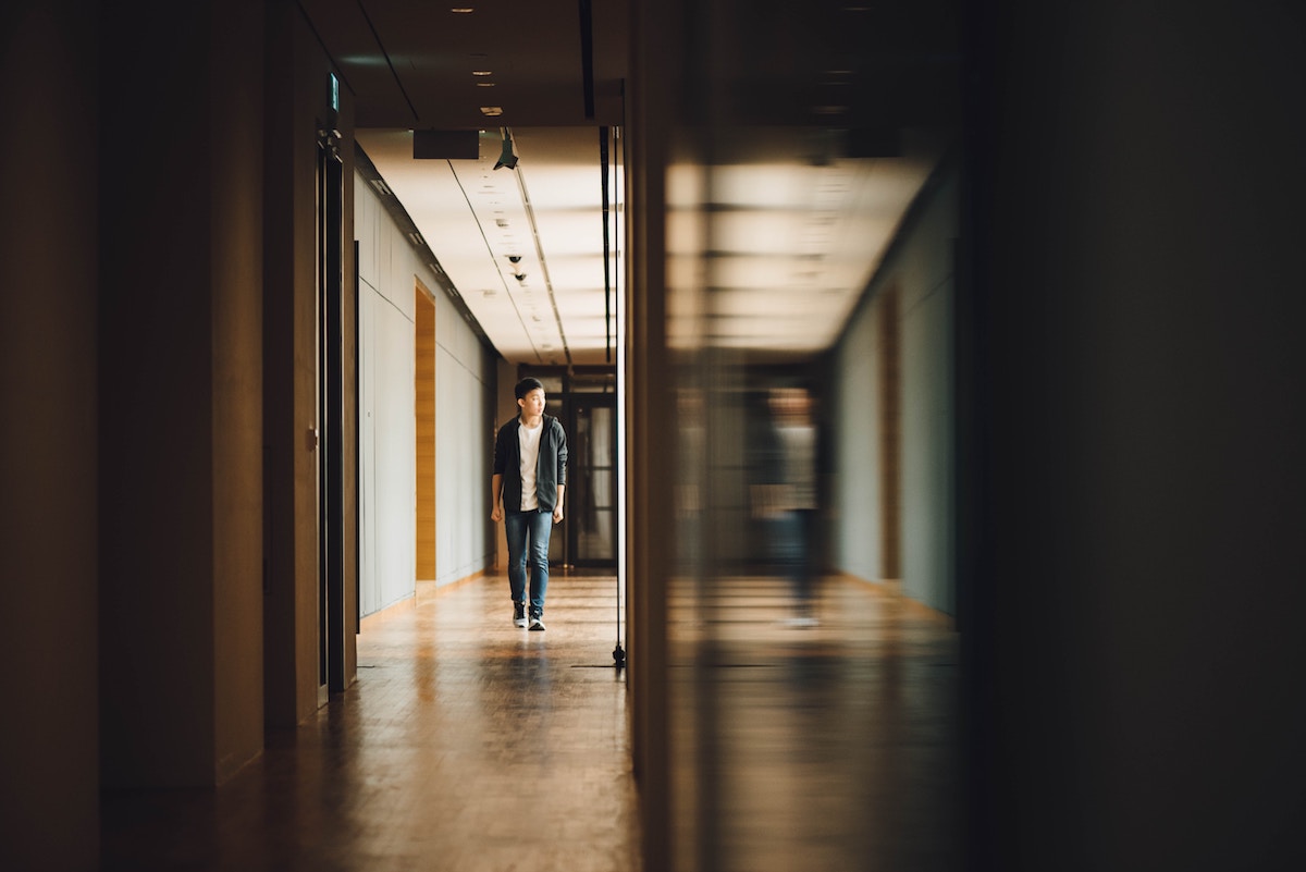 boy by himself in a school hallway