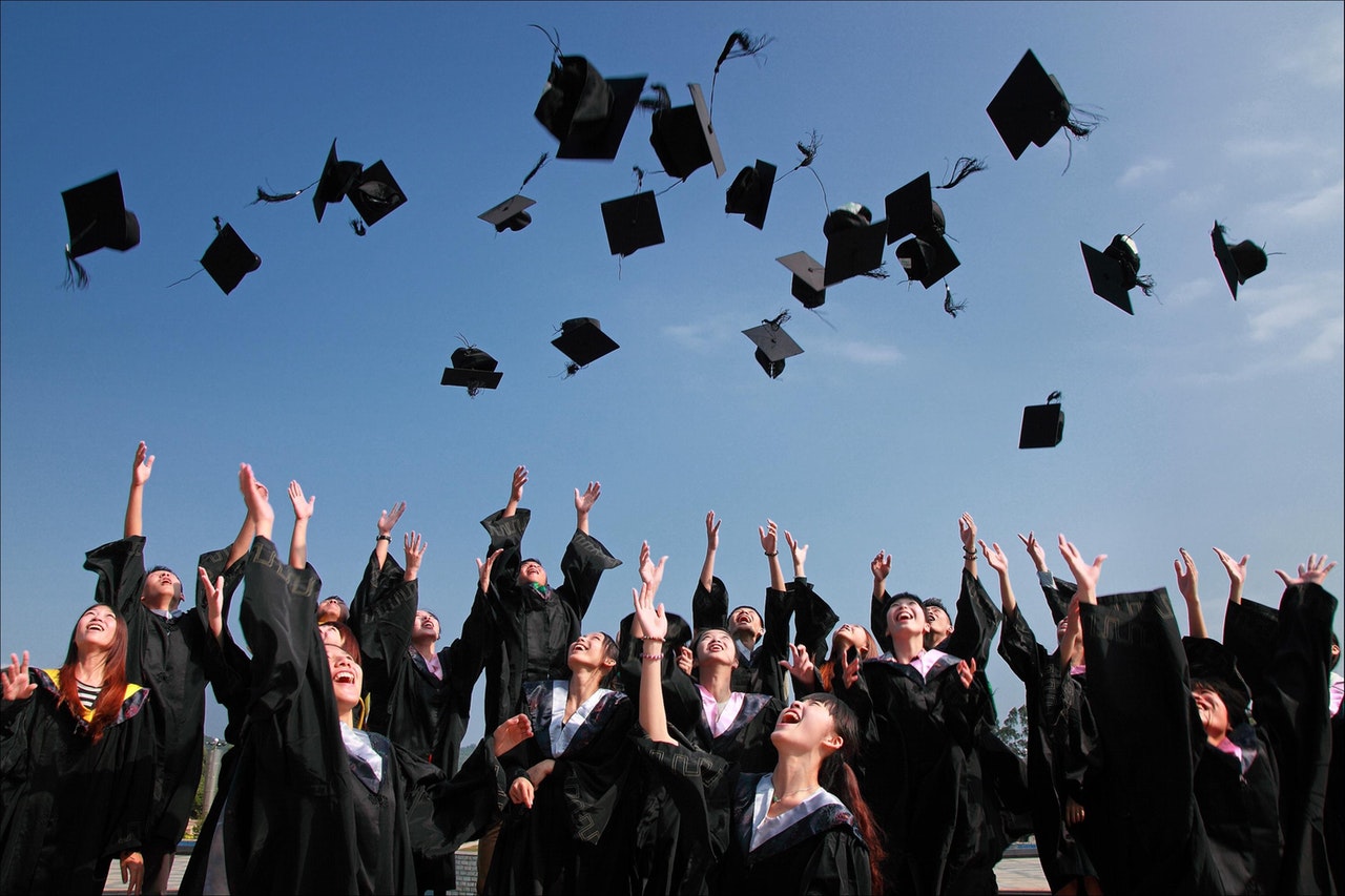 image of students throwing graduation caps student academic success